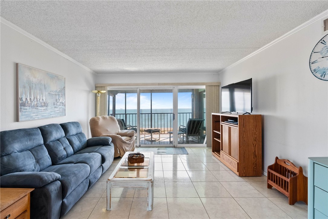 202 Reef Avenue, Unit 407 Corpus Christi, TX 78402 - Photo 8 of 32 Living area with a balcony and water views.