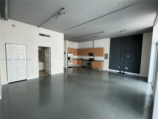 a view of a livingroom with wooden floor and a window