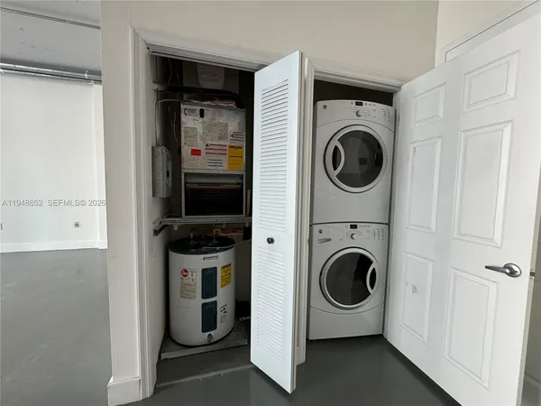 a utility room with sink dryer and washer