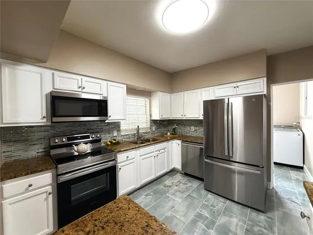 a kitchen with a refrigerator stove and microwave