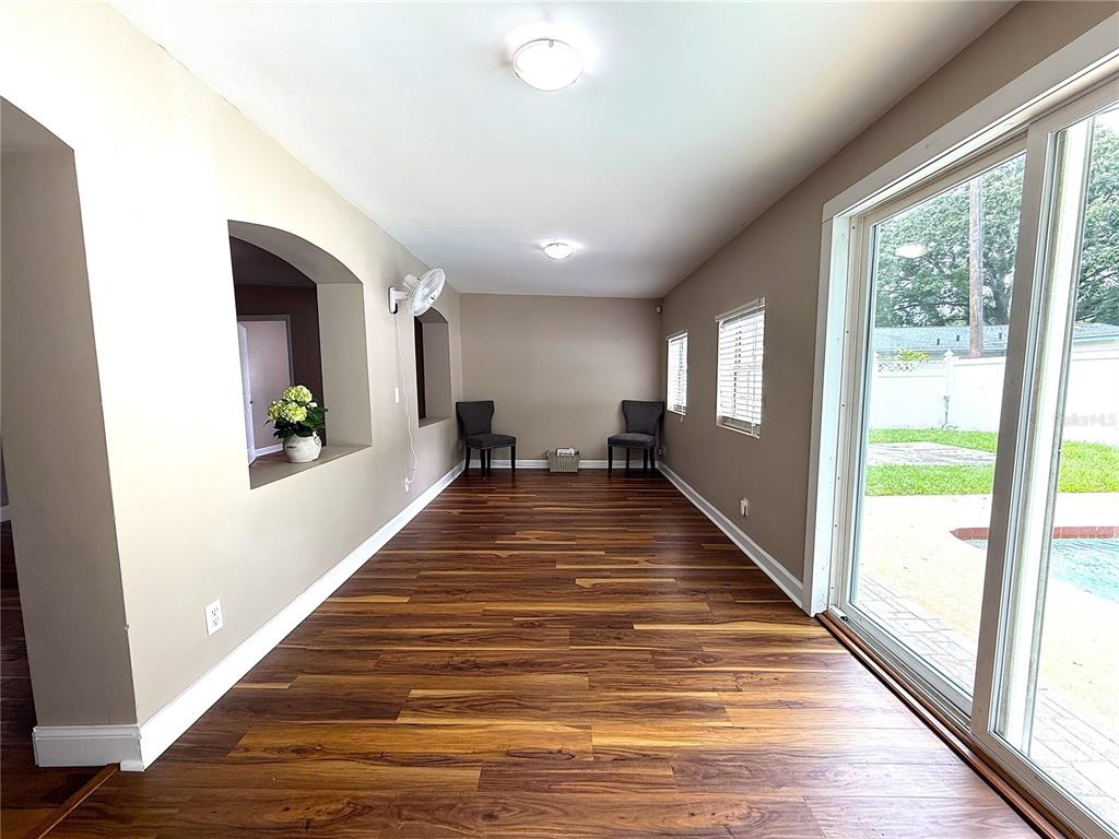 2924 Conway Gardens Road Orlando, FL 32806 - Photo 16 of 36 a view of a hallway with wooden floor and windows