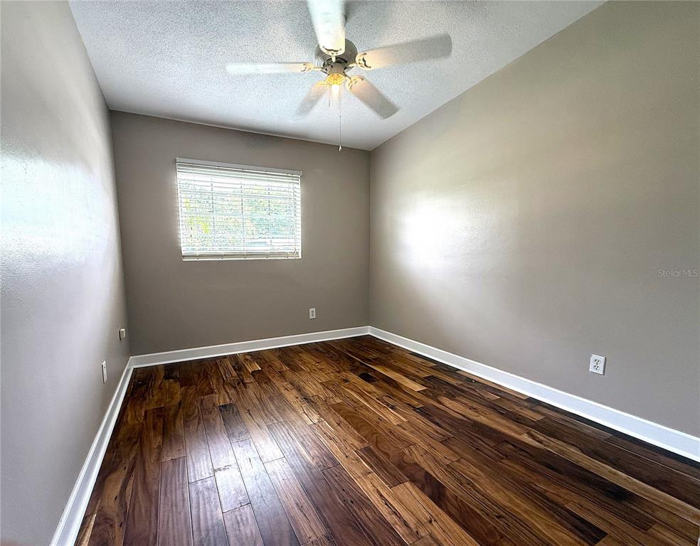 2924 Conway Gardens Road Orlando, FL 32806 - Photo 20 of 36 wooden floor in an empty room with a window
