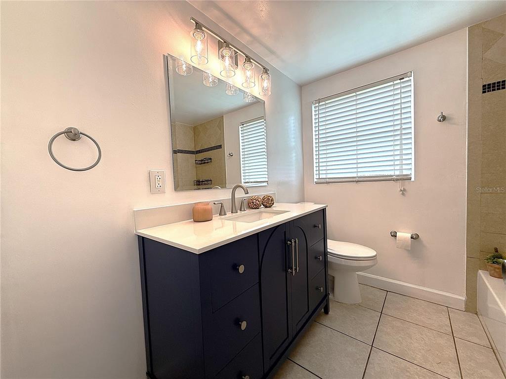 2924 Conway Gardens Road Orlando, FL 32806 - Photo 24 of 36 a bathroom with a sink toilet and mirror