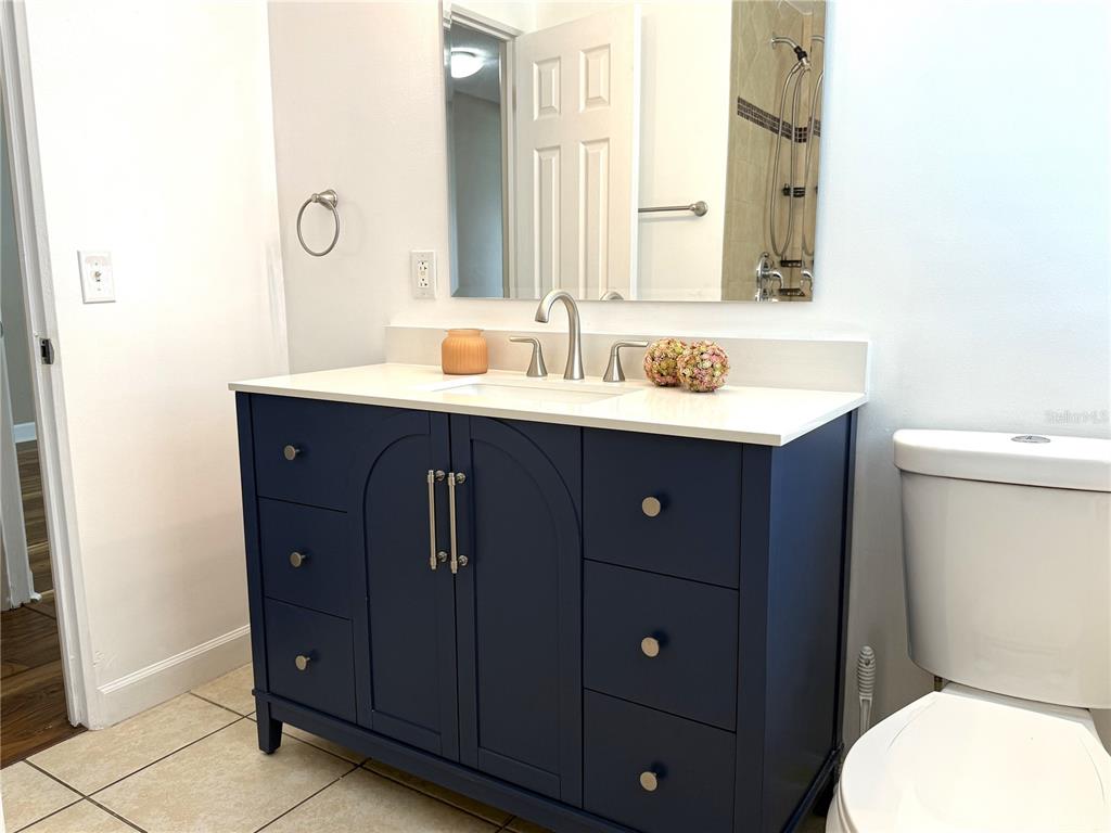 2924 Conway Gardens Road Orlando, FL 32806 - Photo 26 of 36 a bathroom with a toilet a sink and mirror