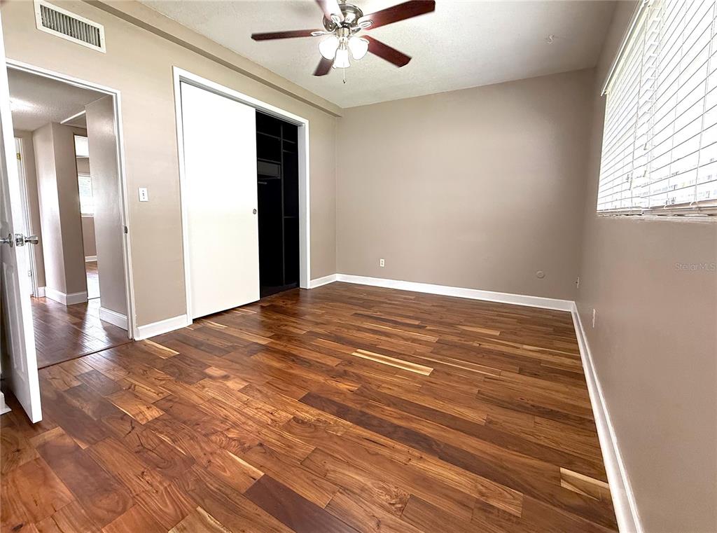 2924 Conway Gardens Road Orlando, FL 32806 - Photo 28 of 36 en empty room with wooden floor and windows