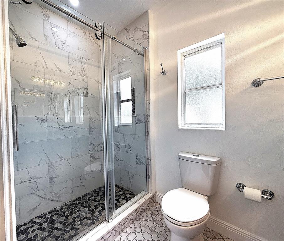 2924 Conway Gardens Road Orlando, FL 32806 - Photo 31 of 36 a bathroom with a toilet and a shower