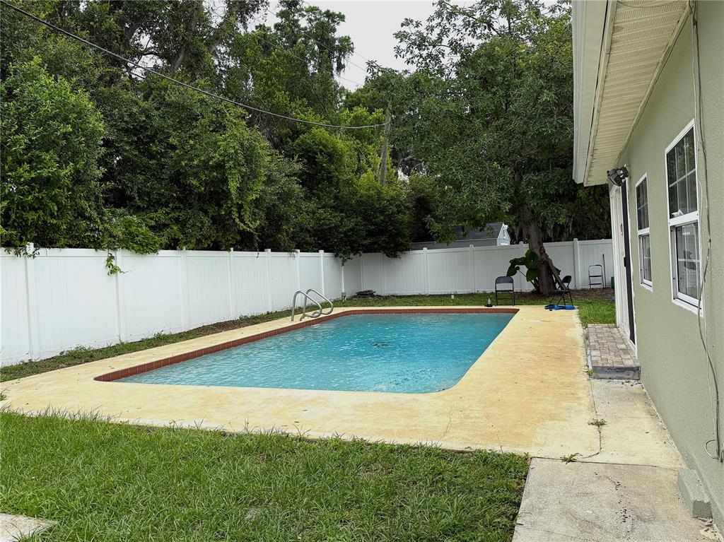 2924 Conway Gardens Road Orlando, FL 32806 - Photo 35 of 36 a view of a swimming pool with an outdoor space and seating area