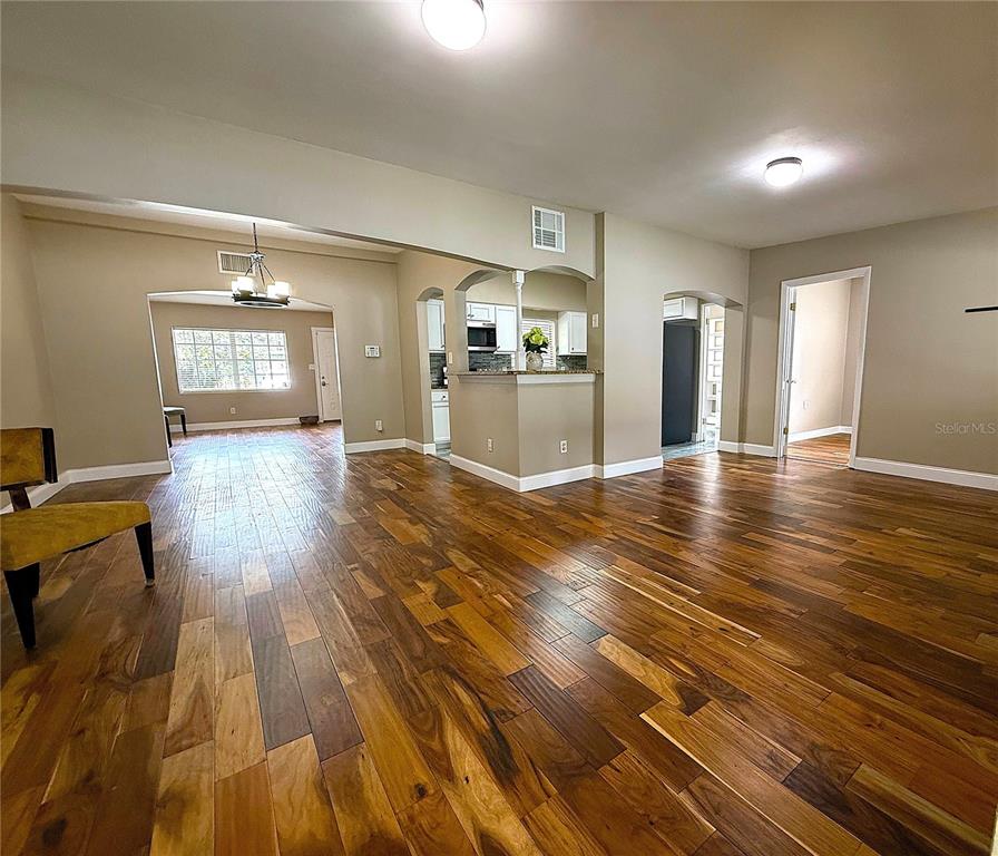 2924 Conway Gardens Road Orlando, FL 32806 - Photo 7 of 36 a view of a livingroom with wooden floor