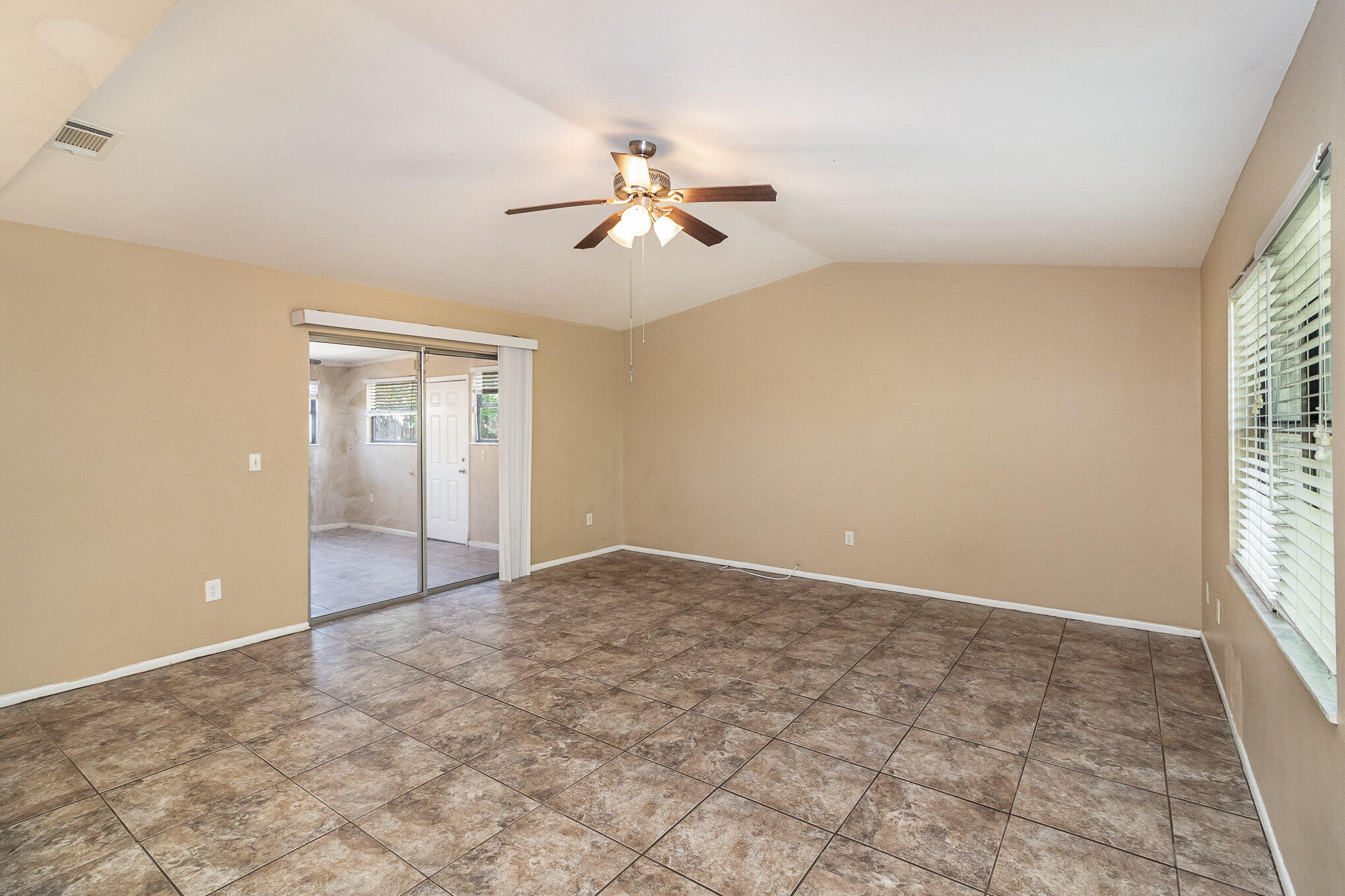 635 Croton Road Melbourne, FL 32935 - Photo 14 of 22 an empty room with windows and fan