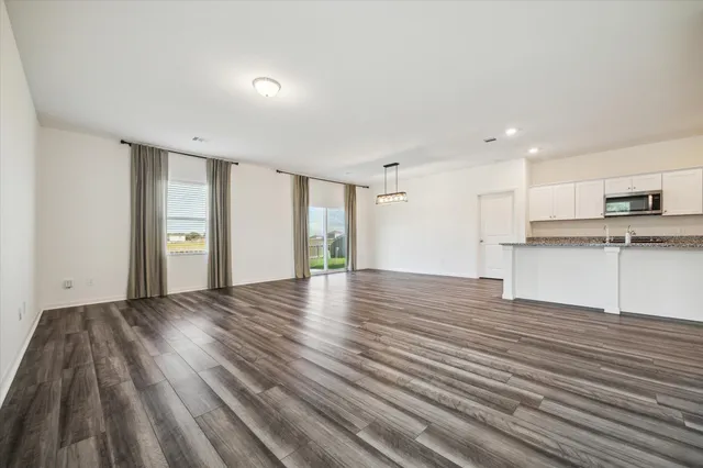 a kitchen with stainless steel appliances a refrigerator and a stove top oven