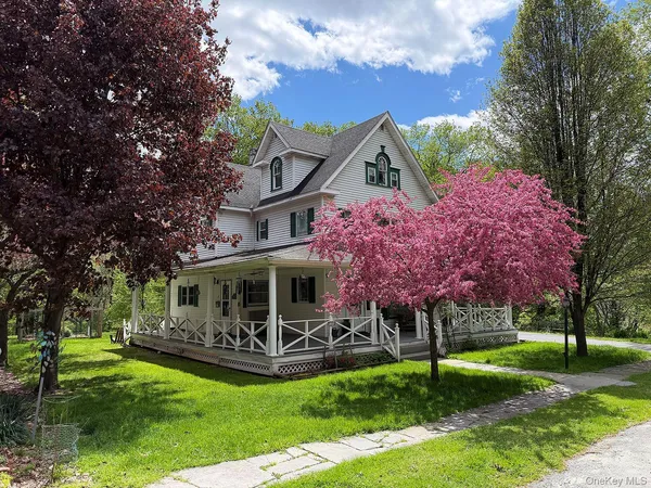 a view of a house with a yard porch and sitting area