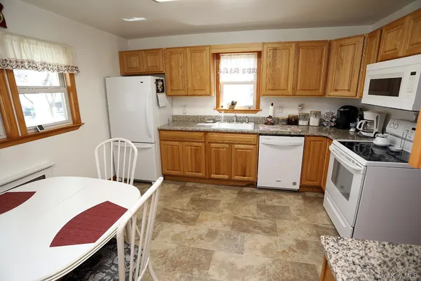 a kitchen with a sink appliances and cabinets
