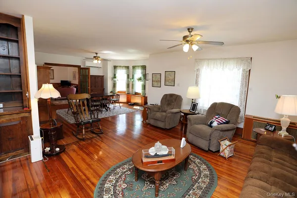 a living room with furniture a rug and a chandelier