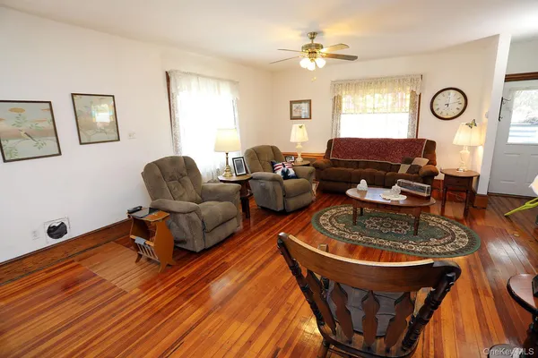 a living room with furniture a fireplace and a window