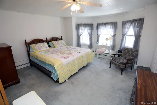 a spacious bedroom with a bed and large windows