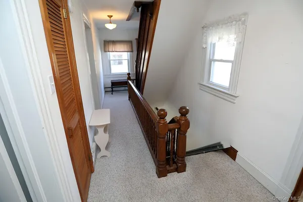 a view of a hallway and a livingroom with furniture