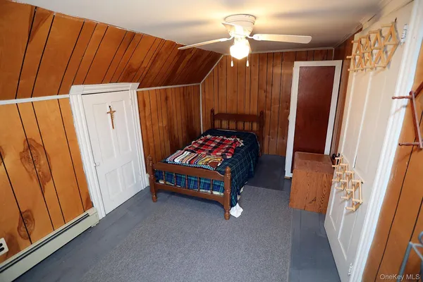 a bedroom with a bed and a mirror
