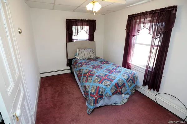 a bedroom with a bed and a mirror