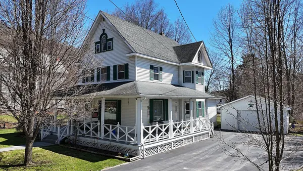 a front view of a house with garage
