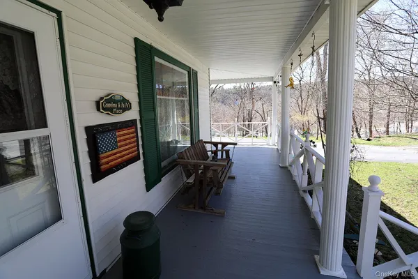 a view of an entryway with wooden floor and door