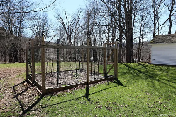 a view of a park with iron fence