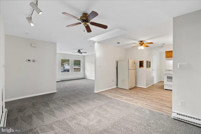 a view of a livingroom with a ceiling fan and window