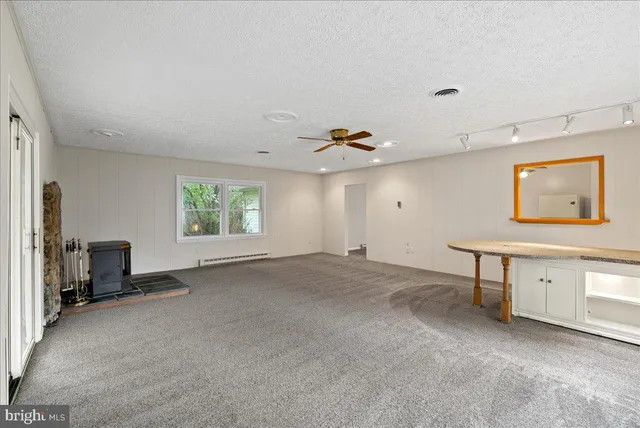 a view of a livingroom with furniture and a window