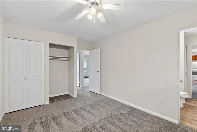 a view of a livingroom with a chandelier fan