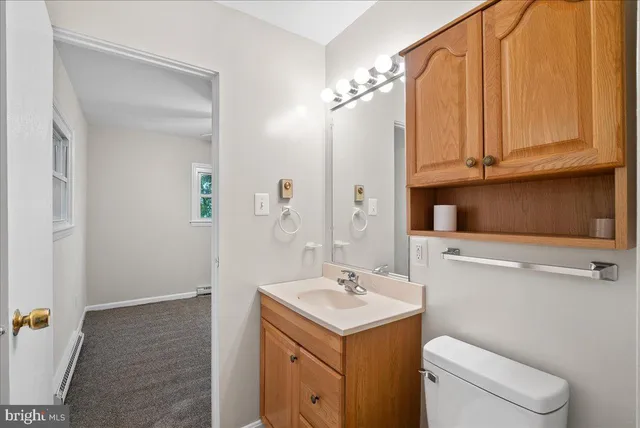 a bathroom with a sink a toilet and vanity