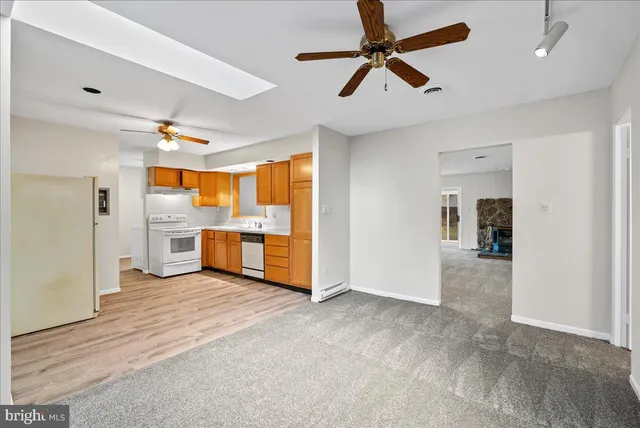 a view of a kitchen with a sink hardwood floor and a ceiling fan