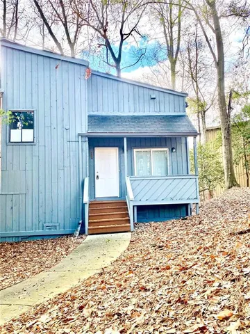 a front view of a house with a wooden fence