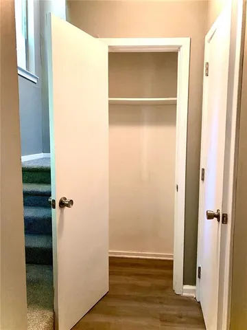 a view of walk in closet with empty racks