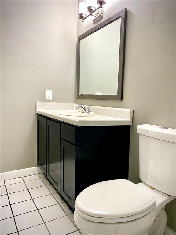 5840 Par Four Court Lithonia, GA 30038 - Photo 18 of 27 a bathroom with a sink a toilet and mirror