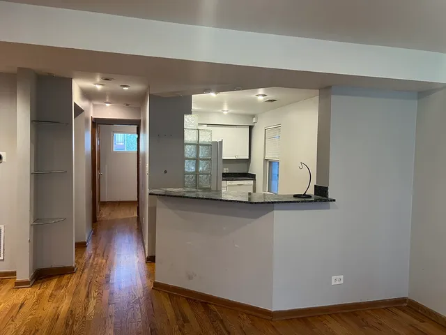 a view of a kitchen cabinets and wooden floor