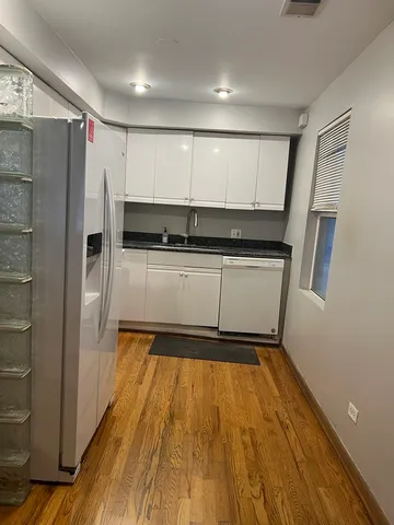 a kitchen with a refrigerator and a sink