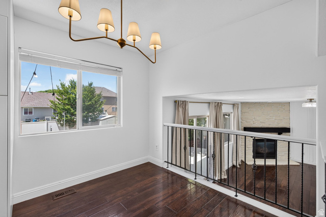 2223 North Pointe Meadow Loop Lehi, UT 84048 - Photo 10 of 56 Open concept interior featuring dark wood-finish flooring, a contemporary bronze chandelier, and crisp white walls