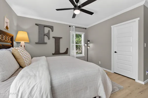 a bedroom with a bed and closet with mirror