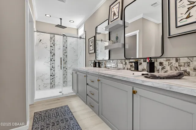 a bathroom with double vanity and a shower