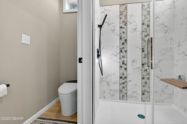 a bathroom with a toilet and a shower
