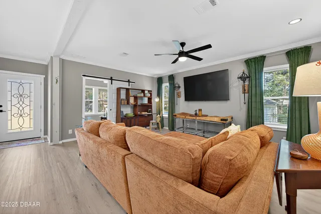 a living room with furniture and a flat screen tv