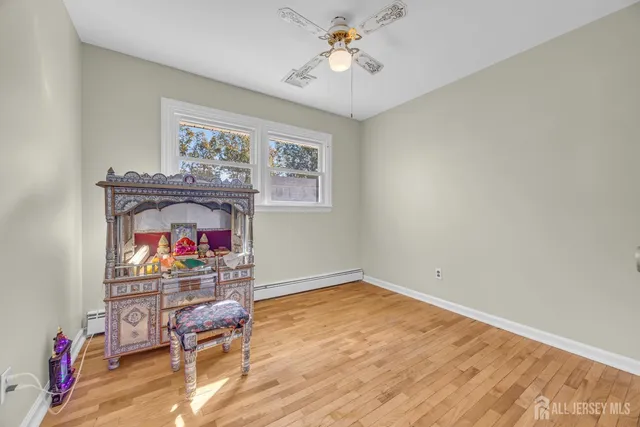 a view of room with window and wooden floor