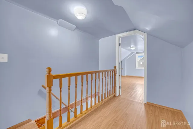 a view of hallway with wooden floor
