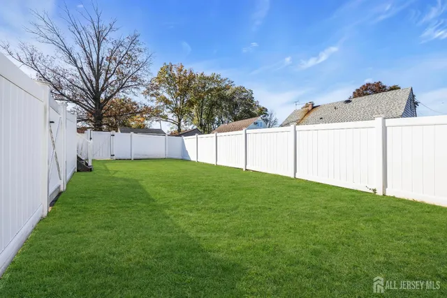 a view of a backyard with large tree