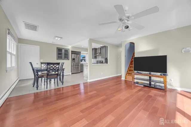 a living room with furniture and a wooden floor