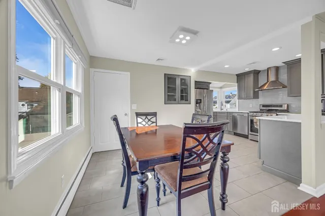 a view of a dining room with furniture and window