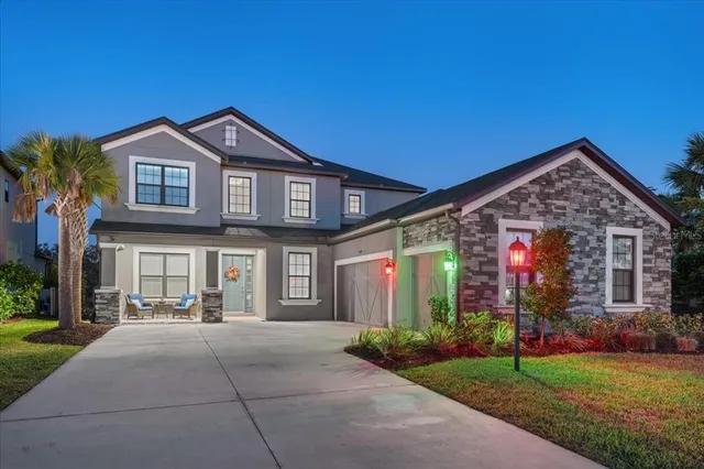 an aerial view of residential houses with outdoor space and trees