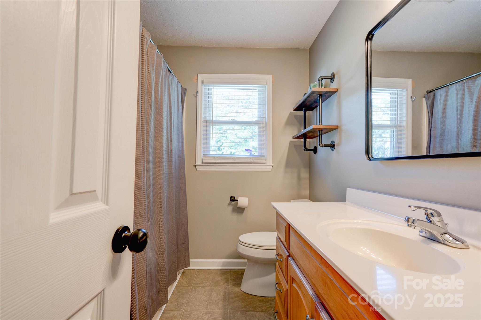3413 Fallston Road Shelby, NC 28150 - Photo 15 of 28 a bathroom with a sink a toilet and shower