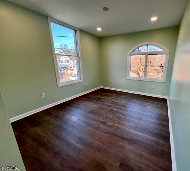 61 Mountainview Boulevard, Unit 4 Wayne, NJ 07470 - Photo 8 of 8 an empty room with wooden floor and windows