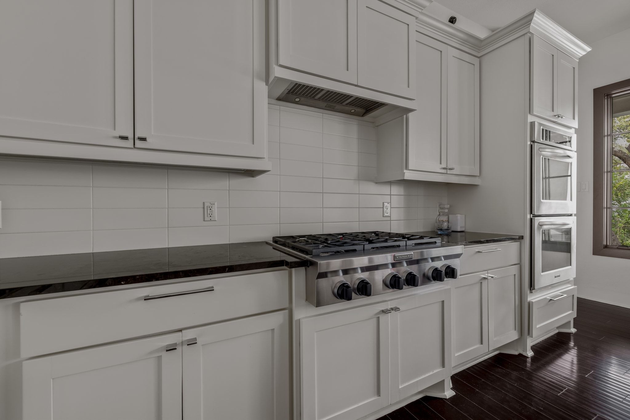 4720 Rockcliff Road, Unit 1 Austin, TX 78746 - Photo 18 of 39 Stainless steel appliances complement the sleek, dark countertops and rich wood flooring in this culinary space.