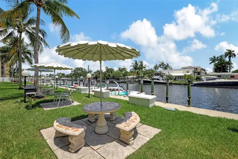 a view of a patio with couches table and chairs and a yard